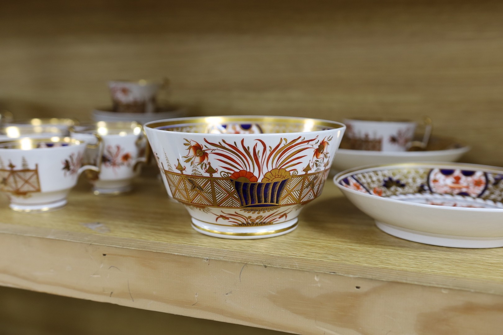 A Spode part Imari tea service consisting of six London shape tea cups, coffee cups and saucers, two graduated saucer dishes and a bowl pattern 1495